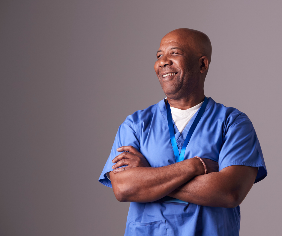 Male nurse smiling with his arms crossed